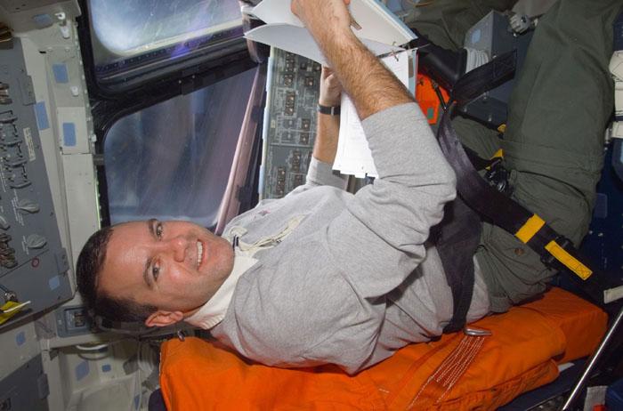 STS102-E-5010 (9 March 2001) --- Astronaut Paul W. Richards, mission specialist, temporarily occupies the commander's station on the forward flight deck of Earth-orbiting Space Shuttle Discovery during late Flight Day 1 activity.