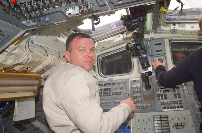 STS102-E-5013 (9 March 2001) --- Astronaut James M. Kelly, pilot, moves toward the control panel on the aft flight deck of the Space Shuttle Discovery toward the end of the initial day in space for the STS-102 astronauts and cosmonaut.
