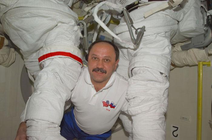 STS102-E-5019 (9 March 2001) --- Cosmonaut Yury V. Usachev, representing Rosaviakosmos, checks out two extravehicular mobility unit (EMU) space suits in the airlock of the Space Shuttle Discovery only hours away from assuming his role as a  full fledged International Space Station crew member. Usachev, Expedition Two commander, and two astronauts are scheduled to trade places with two cosmonauts and an astronaut who have been onboard the orbiting outpost since early November 2000.