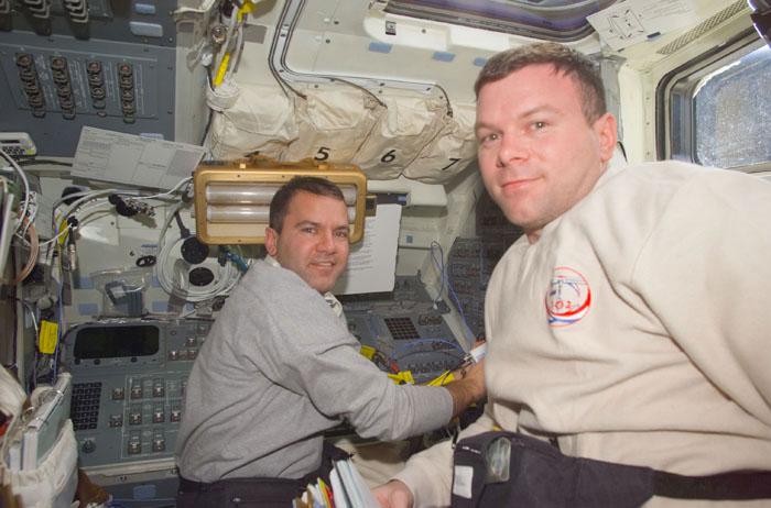 STS102-E-5025 (9 March 2001) --- Astronauts Paul W. Richards (left), mission specialist, and James M. Kelly,   pilot, prepare for tasks on the flight deck of the Space Shuttle Discovery  during STS-102 Flight Day 1 activity.