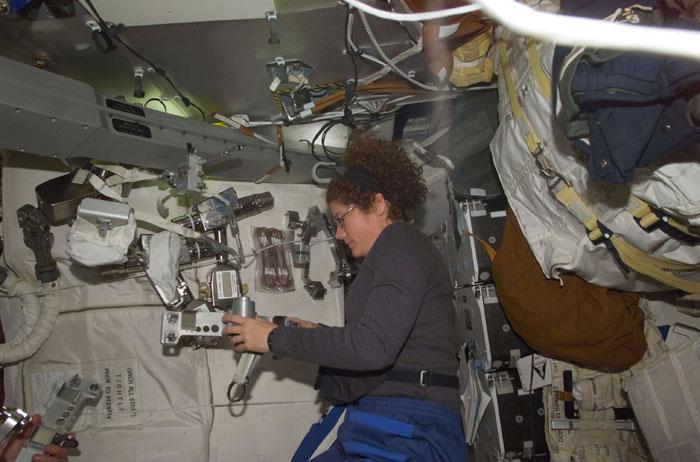 STS102-E-5029 (9 March 2001) --- Astronaut Susan J. Helms, STS-102 mission specialist, checks out some of the space walk gear during Flight Day 1 activity on the mid deck of the Space Shuttle Discovery. Helms is less than two days away from participation in extravehicular activity (EVA).  She will later be part of a three-member crew that will replace the Expedition One crew which has been aboard the International Space Station (ISS) since early November 2000.