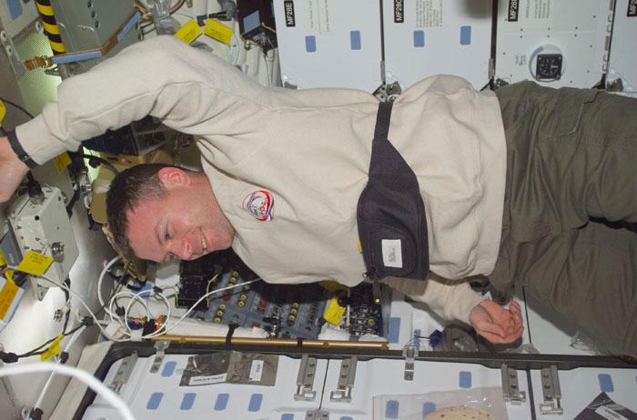 STS102-E-5037 (9 March 2001) --- On the mid deck of the Space Shuttle Discovery, astronaut James M. Kelly, pilot, appears eager to support a series of very busy days on his first trip into space.