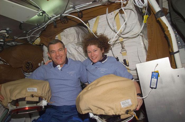 STS102-E-5049  (10 March 2001) --- Astronauts James S. Voss and Susan J. Helms, STS-102 mission specialists, are pictured with supplies on the mid deck. The two astronauts are assigned to space walk duties after the Space Shuttle Discovery and the International Space Station (ISS) link in Earth orbit.  The photograph was recorded with a digital still camera.