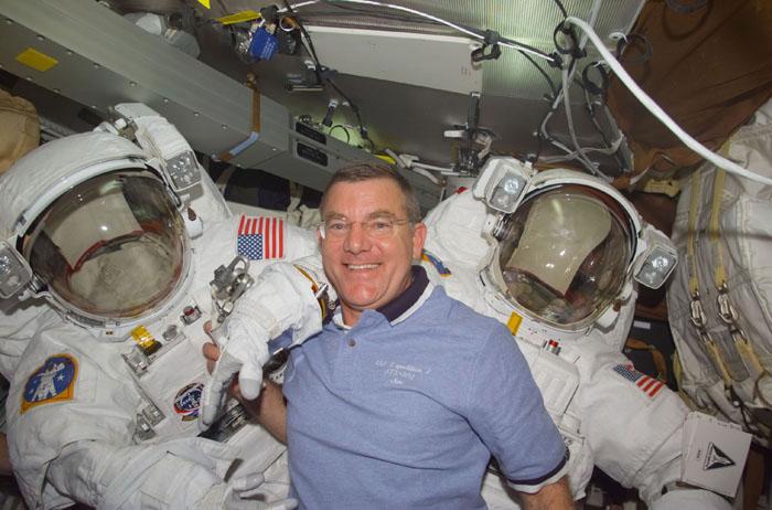 STS102-E-5057  (10 March 2001)  ---  Astronaut James S. Voss,  STS-102 mission specialist, poses with both Extravehicular Mobility Unit (EMU)  space suits on the mid deck.  Voss is one of two astronauts assigned to space walk duties after the Space Shuttle Discovery and the International Space Station (ISS) link in Earth orbit.  The photograph was recorded with a digital still camera.