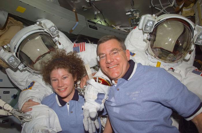 STS102-E-5061  (10 March 2001)  --- Astronauts James S. Voss and Susan J. Helms, STS-102 mission specialists, are pictured with their Extravehicular Mobility Unit (EMU) space suits on the mid deck.  The two astronauts are assigned to space walk duties after the Space Shuttle Discovery and the International Space Station (ISS) link in Earth orbit.  The photograph was recorded with a digital still camera.