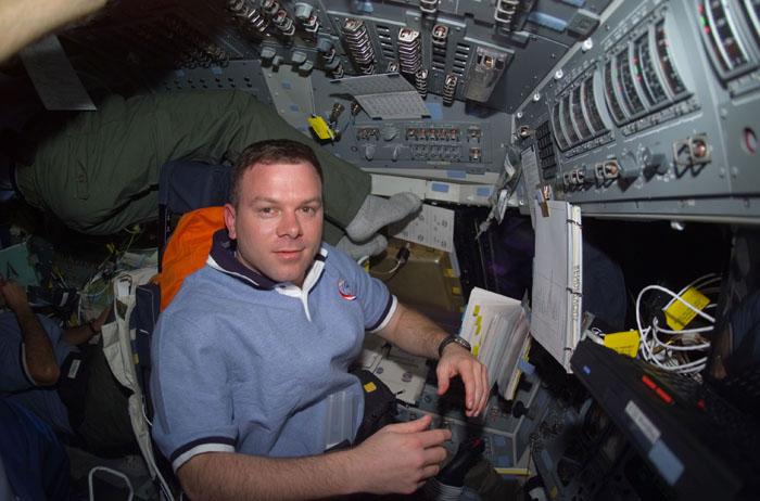 STS102-E-5075  (10 March 2001) --- Astronaut James M. Kelly, pilot, is about to be busy on Discovery's forward flight deck during rendezvous operations with the International Space Station (ISS).  The photograph was recorded with a digital still camera.