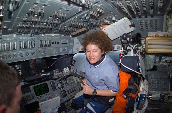 STS102-E-5084  (10 March 2001) --- Astronaut Susan J. Helms, STS-102 mission specialist, is pictured at the pilot's station on the flight deck.  Helms is one of two astronauts assigned to space walk duties after the Space Shuttle Discovery and the International Space Station (ISS) link in Earth orbit. The photograph was recorded with a digital still camera.