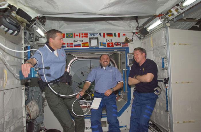 STS102-E-5094 (10 March 2001) --- Left to right, astronaut James D. Wetherbee, STS-102 commander; cosmonaut Yury V. Usachev, Expedition Two commander;  and astronaut William M. (Bill) Shepherd, Expedition One commander, converse in the Destiny laboratory shortly after hatches were open following docking of the Space Shuttle Discovery and the International Space Station (ISS). The photograph was recorded with a digital still camera.