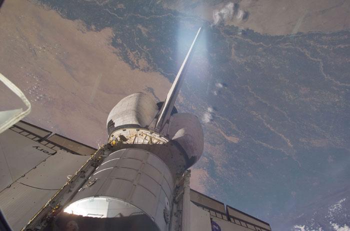 STS102-E-5111  (10 March 2001) --- An out-the-window view of the Leonardo Multi Purpose Logistics Module resting in Discovery's payload bay  was recorded with a digital still camera from the International Space Station (ISS)  Earth is in the background.