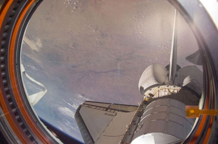 STS102-E-5114 (10 March 2001) --- An out-the-window view of the Leonardo Multi Purpose Logistics Module resting in Discovery's payload bay  was recorded with a digital still camera from the International Space Station (ISS).   Earth is in the background.