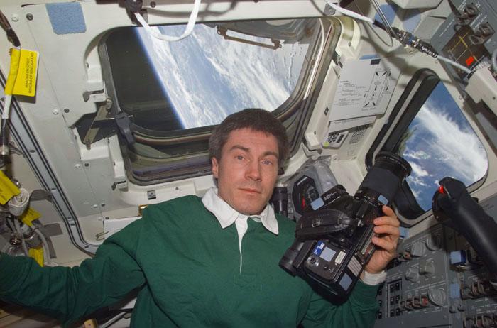 STS102-E-5142 (12 March 2001) --- Cosmonaut Sergei K. Krikalev, now a member of the STS-102 crew, prepares to use a camera on Discovery's flight deck. Krikalev, representing Rosaviakosmos, had been onboard the International Space Station (ISS) since early November 2000.  The photograph was taken with a digital still camera.