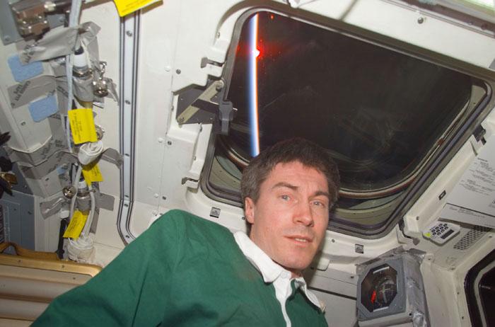 STS102-E-5147 (12 March 2001) --- Cosmonaut Sergei K. Krikalev, now a member of the STS-102 crew on Discovery's flight deck. A sun setting can be seen through the flight deck windows in the background.  Krikalev, representing Rosaviakosmos, had been onboard the International Space Station (ISS) since early November 2000.  The photograph was taken with a digital still camera.