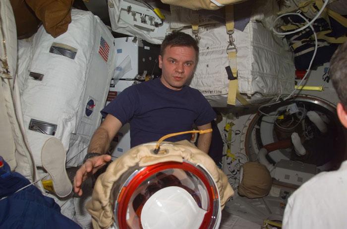 STS102-E-5152  (13 March 2001) --- Cosmonaut Yuri P. Gidzenko, now a member of the STS-102 crew, on Discovery's mid deck with extravehicular mobility unit (EMU) space suits.  Gidzenko, representing Rosaviakosmos, had been onboard the International Space Station (ISS) since early November 2000.  The photograph was taken with a digital still camera.