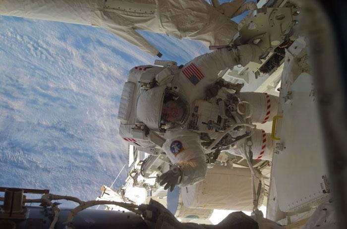 STS102-E-5194 (13 March 2001) --- Astronaut Paul W. Richards,  mission specialist, waves toward his crew mate during the second STS-102 space walk.  The picture was taken with a digital still camera.