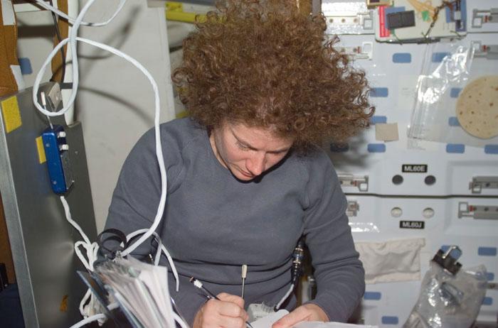 STS102-E-5206 (13 March 2001) --- Astronaut Susan J. Helms enters notes on the mid deck of the Space Shuttle Discovery. The photograph was taken with a digital still camera.