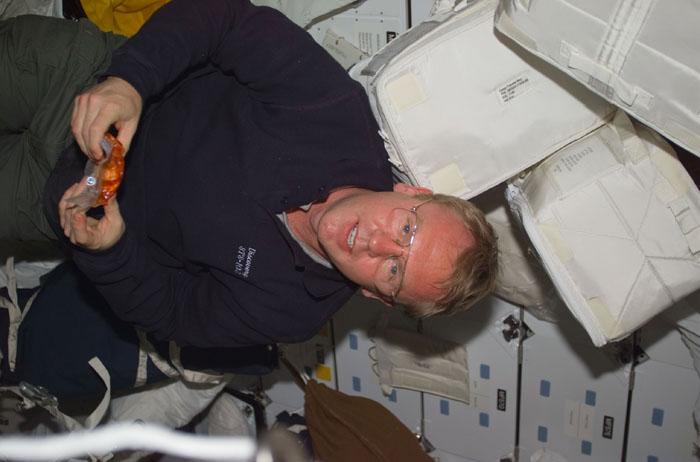 STS102-E-5210 (14 March 2001) -- Astronaut Andrew S.W. Thomas, mission specialist, takes a break from moving chores to enjoy a snack on Discovery's mid deck.  The image was recorded with a  digital still camera.