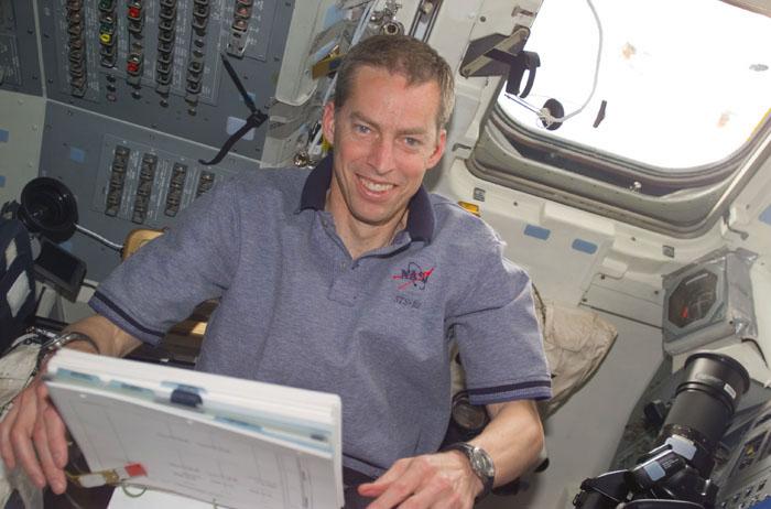 STS102-E-5213 (14 March 2001) --- Astronaut James D. Wetherbee, mission commander, is pictured in a low angle view looking over a flight plan on the aft flight deck of the Space Shuttle Discovery.  The image was recorded with a digital still camera.