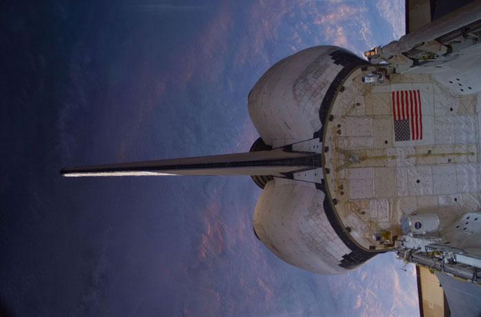 STS102-E-5278 (17 March 2001) --- This scene of the aft portion of the Space Shuttle Discovery, backdropped against a massive cloud cover on Earth, was recorded with a digital still camera from inside the International Space Station (ISS) while the two spacecraft were linked together to accomplish more work on the station and exchange crew personnel assigned to man it.