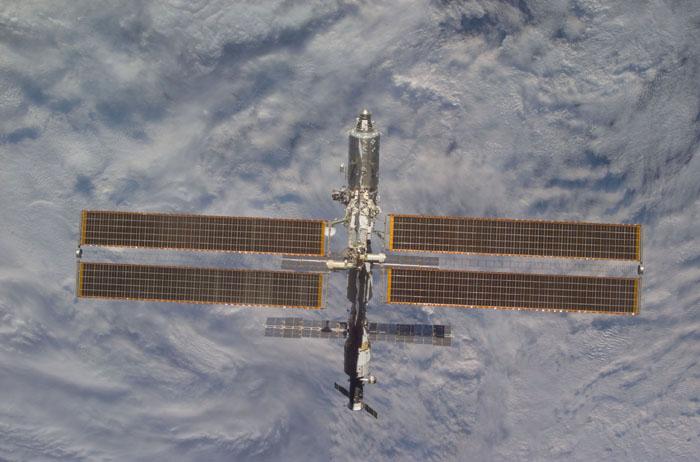 STS102-E-5315 (18 March 2001) --- The International Space Station (ISS) backdropped against a mass of clouds over Earth was photographed with a digital still camera from the Space Shuttle Discovery on March 18, 2001.  It is a standard operation for the shuttle to make a final fly-around of the outpost following unlinking from it. A new crew comprised of cosmonaut Yury V. Usachev and astronauts James S. Voss and Susan J. Helms will spend several months aboard the station.