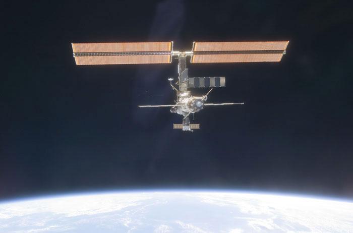 STS102-E-5345 (18 March 2001) --- The International Space Station (ISS) backdropped against black space  above Earth's horizon was photographed with a digital still camera from the Space Shuttle Discovery on March 18, 2001.  It is a standard practice for the shuttle to make a final fly-around of the outpost following unlinking from it. A new crew comprised of cosmonaut Yury V. Usachev and astronauts James S. Voss and Susan J. Helms will spend several months aboard the station.