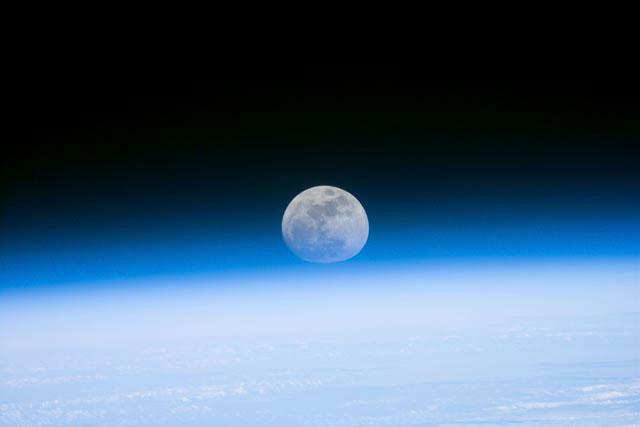 S103-E-5037 (21 December 1999)--- Astronauts aboard the Space Shuttle Discovery recorded this rarely seen phenomenon of the full Moon partially obscured by the atmosphere of Earth. The image was recorded with an electronic still camera at 15:15:15 GMT, Dec. 21, 1999.