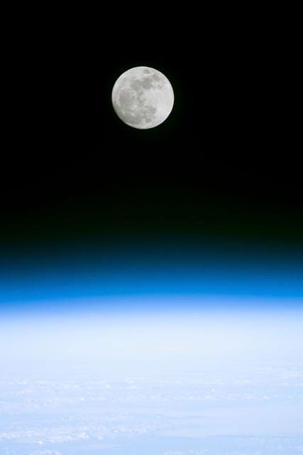 STS103-E-5040 (21 December 1999) --- This photo of the Moon over the airglow  of Earth's atmosphere was taken by the STS-103 crew members aboard Discovery.  Time of the electronic still camera's (ESC) image was 15:15:41 GMT, Dec. 21, 1999.
