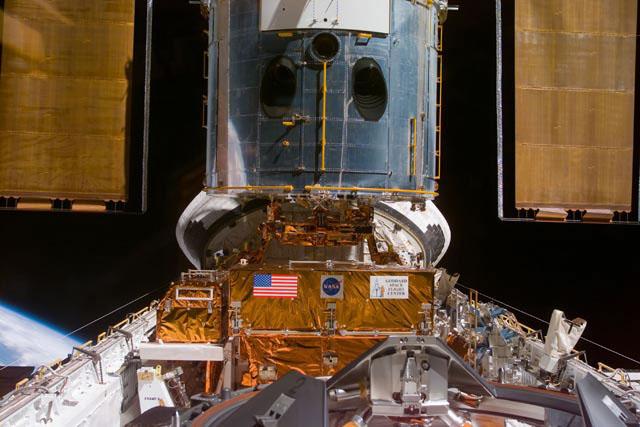 S103-E-5165 (21 December 1999) --- This electronic still camera's view and others in this series showing the Hubble Space Telescope (HST) berthed in Discovery's bay were recorded soon after capture and downlinked at the completion of the mission's first space walk on the following day by the busy STS-103 astronauts. The image was recorded at 19:47:57 GMT, Dec. 21, 1999.