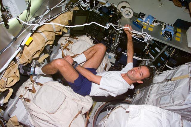 S103-E-5188 (21 December 1999) --- Astronaut Jean-Francois Clervoy, mission specialist representing the European Space Agency (ESA), has established  a computer workstation on Discovery's mid deck. This photo was taken with an  electronic still camera (ESC) at 10:43:07 GMT, Dec. 21, 1999.