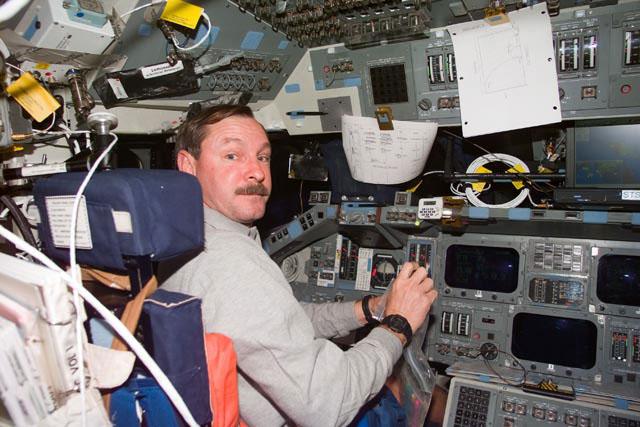 S103-E-5200 (21 December 1999) --- Astronaut Curtis L. Brown Jr. mans the commander's station during Flight Day 2 activity onboard the Space Shuttle Discovery. Brown and his crew will capture  the Hubble Space Telescope (HST) in order to perform a number of servicing tasks.  The photo was taken with an electronic still camera (ESC) at 11:11:57 GMT, Dec. 21, 1999.
