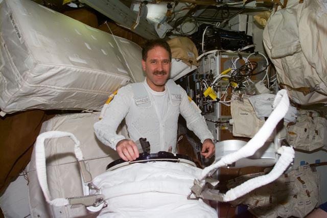 STS103-E-5243 (22 December 1999) ---  Astronaut John M. Grunsfeld, mission specialist, on Discovery's mid deck  wearing the thermal undergarment which  complements the extravehicular mobility unit (EMU) space suit. Grunsfeld joined  astronaut Steven L. Smith for the first  scheduled space walk on this the third NASA visit to HST. This photo was taken with an electronic still camera (ESC).