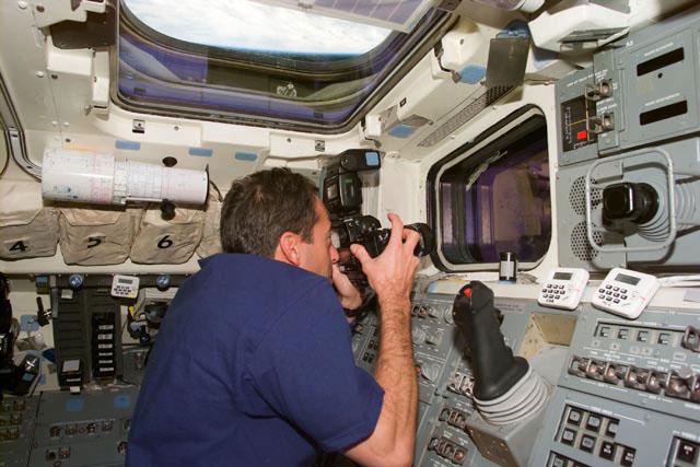 S103-E-5247 (22 December 1999) --- Astronaut Jean-Francois Clervoy, mission specialist representing the European Space Agency (ESA), takes out-the-window pictures during the first space walk on  this third visit by NASA astronauts to service the Hubble Space Telescope (HST).