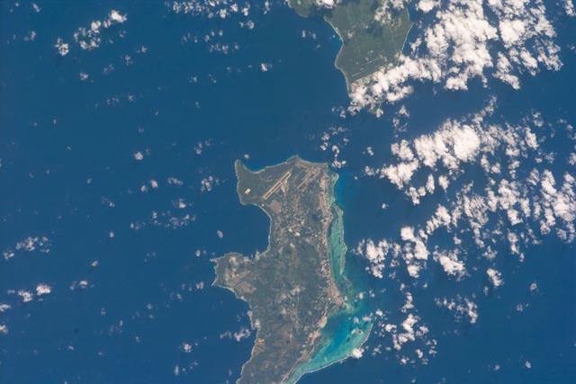 S103-E-5361 (24 December 1999) --- This vertical view from the Space Shuttle Discovery shows two small islands of the Marianas Islands (Saipan and Tinian) in Micronesia in the Pacific Ocean. The STS-103 crew recorded this electronic still image at 28:05:53 GMT, December 24, 1999.