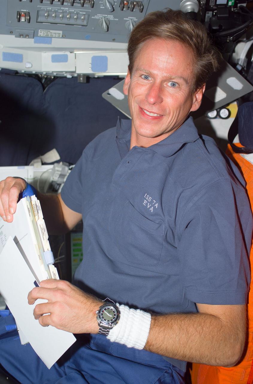STS104-E-5022 (14 July 2001) --- Astronaut Michael L. Gernhardt, STS-104 mission specialist, gathers flight data prior to rendezvous between the Space Shuttle Atlantis and the International Space Station (ISS).  A crew mate took this picture with a digital still camera.