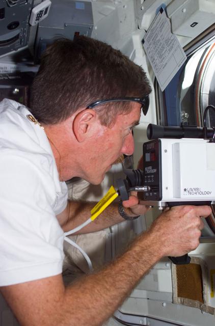 NASA image: MS Reilly with laser range finder on aft flight deck