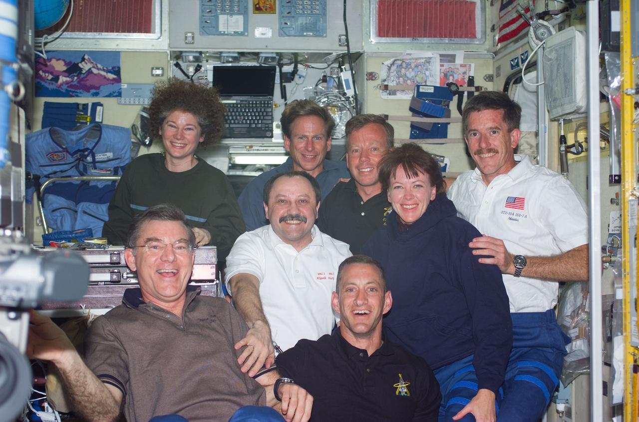 S104-E-5057 (14 July 2001) --- Soon after their ingress into the International Space Station (ISS), the STS-104 crewmembers pose for a photograph with the Expedition Two crewmembers in the Zvezda Service Module.  From left to right are: back row - Susan J. Helms, Expedition Two flight engineer; Michael L. Gernhardt, STS-104 mission specialist; Steven W. Lindsey, STS-104; James F. Reilly, STS-104 mission specialist; middle row - Yury V. Usachev, Expedition Two mission commander; Janet L. Kavandi, STS-104 mission specialist; front row - James S. Voss, Expedition Two flight engineer; and Charles O. Hobaugh, STS-104 pilot.  Usachev represents Rosaviakosmos.