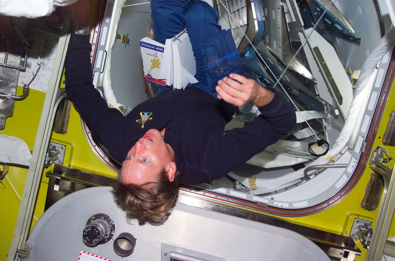 STS104-E-5164 (19 July 2001) ---  Astronaut Michael L. Gernhardt, STS-104 mission specialist, floats in the Quest Airlock prior to getting suited for the second of three scheduled STS104 space walks to work on the exterior of the International Space Station (ISS).    The image was recorded with a digital still camera.