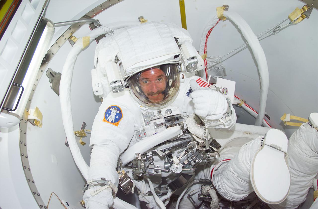 STS104-E-5203 (20 July 2001) --- Though it was a bit before Friday midnight in Houston, it was already into the morning hours of Saturday by Greenwich Mean Time (GMT) when astronauts James F. Reilly (facing camera) and Michael L. Gernhardt were photographed with a digital still camera in the Crew Lock prior to depressurization of the compartment for the third and final space walk of STS-104.