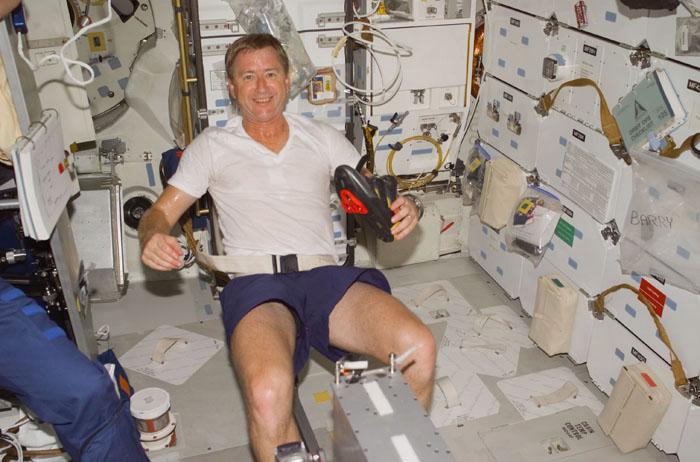 STS105-E-5004 (10 August 2001) ---  Astronaut Frank L. Culbertson Jr., on his way to the International Space Station (ISS) to serve as Expedition Three commander, exercises on a bicycle ergometer on the mid deck of the Space Shuttle Discovery.  The image was recorded with a digital still camera.