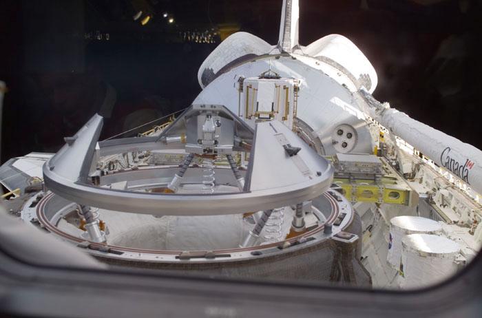STS105-E-5018 (11 August 2001) --- One of the STS-105 crew members on the flight deck of the Earth-orbiting Space Shuttle Discovery used a digital still camera to record this image of the Orbiter Docking System's docking mechanism in the cargo bay. The shuttle's Canadarm or Remote Manipulator System (RMS) arm is in its stowed position on the port side.