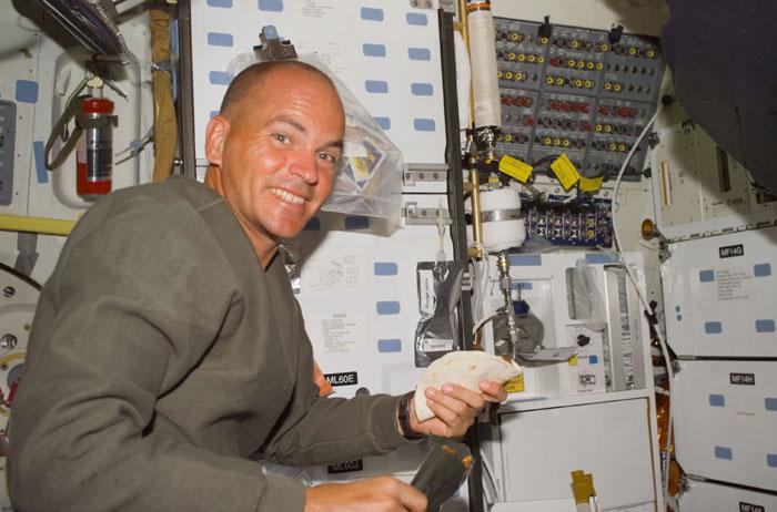 STS105-E-5035 (11 August 2001) --- Astronaut Frederick W. Sturckow, STS-105 pilot, makes a sandwich at the gallery on the mid deck of the Space Shuttle Discovery as he takes a break from flight day two activities.  The STS-105 crew spent part of the day preparing for the rendezvous and docking with the International Space Station (ISS).