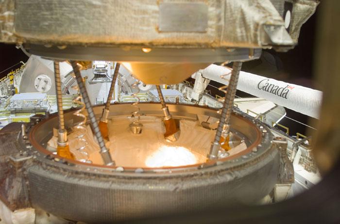 STS105-E-5067 (12 August 2001) --- One of the STS-105 crew members on the aft flight deck of the Space Shuttle Discovery used a digital still camera to record this close-up view of the docking process between the shuttle and the International Space Station (ISS). The shuttle&#0146;s Canadarm or Remote Manipulator System (RMS) arm is in its stowed position at right.
