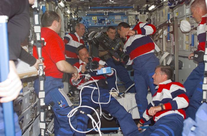 STS-105-E-5097 (12 August 2001) --- Expedition Two, Expedition Three and STS-105 crewmembers work with some video equipment in the U.S. Laboratory.  From left to right are: cosmonaut Yury V. Usachev, Expedition Two mission commander; Daniel T. Barry, STS-105 mission specialist; Scott J. Horowitz, STS-105 commander - holding a camcorder; James S. Voss, Expedition Two flight engineer - holding a high definition video camera; cosmonaut Vladimir N. Dezhurov, Expedition Three flight engineer; Frank L. Culbertson, Expedition Three mission commander; and Patrick G. Forrester, STS-100 mission specialist.  This image was taken with a digital still camera.