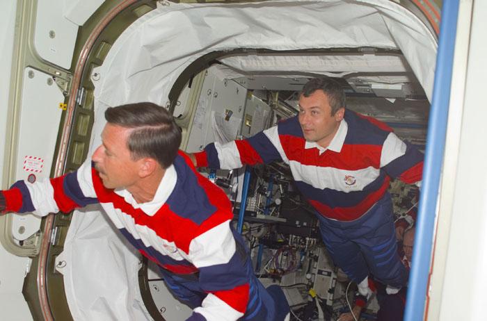 STS105-E-5109 (12 August 2001) --- Scott J. Horowitz (left), STS-105 commander, and cosmonaut Vladimir N. Dezhurov, Expedition Three flight engineer, move into Unity Node 1 during the initial ingress into the International Space Station (ISS) during the STS-105 mission.  Dezhurov, accompanied by cosmonaut Mikhail Tyurin and astronaut Frank L. Culbertson, Jr., will be replacing astronauts Susan J. Helms and James S. Voss and cosmonaut Yury V. Usachev as the temporary residents of the ISS.  This image was taken with a digital still camera.