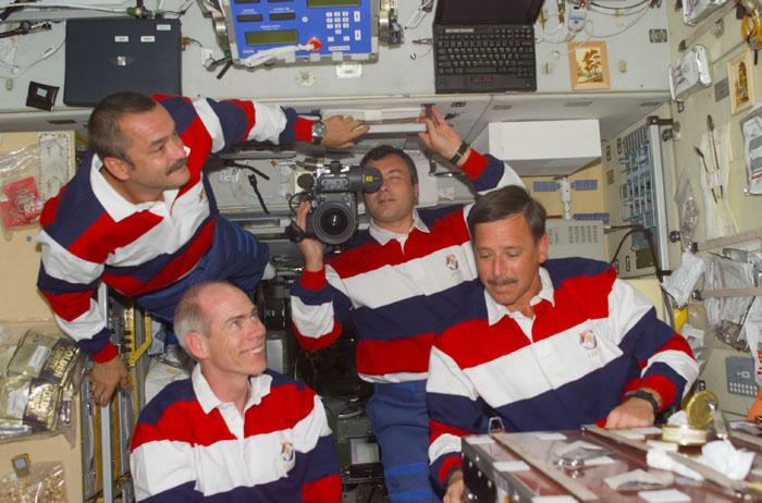 STS-105-E-5132 (12 August 2001) --- Expedition Three and STS-105 crewmembers get familiar with the Zvezda Service Module during the initial ingress into the International Space Station (ISS) for the STS-105 mission.  Clockwise from the top left are: cosmonaut Mikhail Tyurin, Expedition Three flight engineer; cosmonaut Vladimir N. Dezhurov   (using a high definition video camera),  Expedition Three flight engineer; Scott J. Horowitz, STS-105 commander; and Daniel T. Barry, STS-105 mission specialist.  This image was taken with a digital still camera.