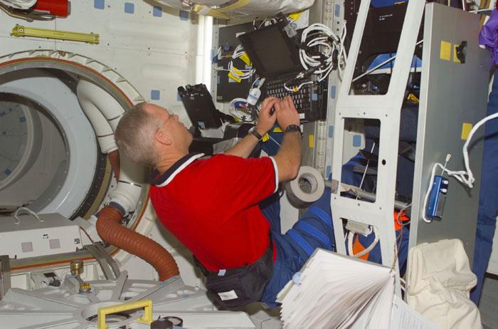 STS105-E-5158 (13 August 2001) --- Astronaut Patrick G. Forrester, STS-105 mission specialist, inputs data on a laptop computer on the mid deck of the Space Shuttle Discovery, which is currently docked to the International Space Station (ISS). The image was recorded with a digital still camera.