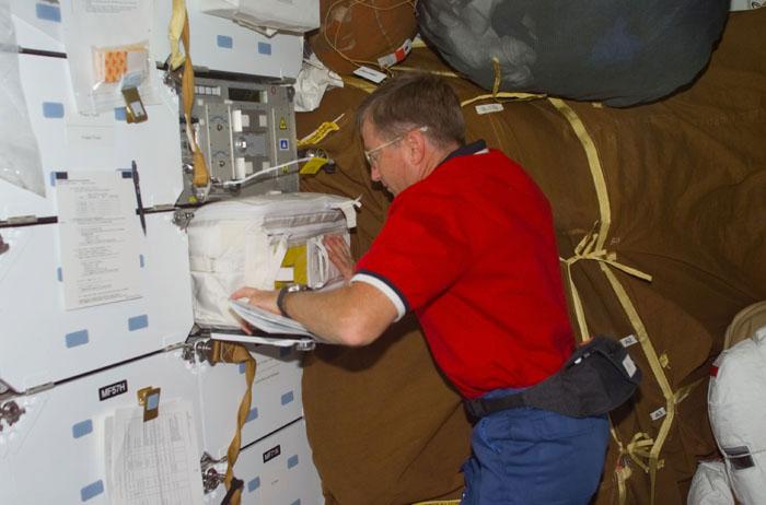 STS105-E-5160 (13 August 2001) --- Astronaut Frank L. Culbertson, Jr., Expedition Three mission commander, works with Dreamtime equipment on the mid deck of the Space Shuttle Discovery. Dreamtime is NASA's commercial collaborator on multi-media activities. This image was taken with a digital still camera.
