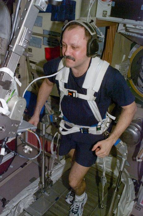 STS105-E-5172 (13 August 2001) ---  Astronaut Yury V. Usachev works out on the treadmill device in the Zvezda Service Module aboard the International Space Station (ISS).  The Expedition Two mission commander, who represents Rosaviakosmos, is only days away from returning to Earth following five months aboard the orbital outpost.  The image was recorded with a digital still camera.