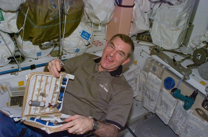 STS105-E-5175 (13 August 2001) --- Astronaut James S. Voss, retrieves  a small tool from a tool case in the U.S.-built Unity node aboard the International Space Station (ISS).  The Expedition Two flight engineer is only days away from returning to Earth following five months aboard the orbital outpost.  The image was recorded with  a digital still camera.