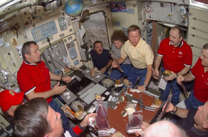 STS105-E-5198 (15 August 2001) --- Ten astronauts and cosmonauts dine in the Zvezda Service Module.  Clockwise from lower left corner are Scott J. Horowitz, Frederick W. (Rick) Sturckow, Vladimir N. Dezhurov, Mikhail Tyurin, Susan J. Helms, Frank L. Culbertson, Yury V.  Usachev, James S. Voss and Patrick G. Forrester.  Daniel T. Barry is out of frame at lower right. Dezhurov, Tyurin and Usachev  represent Rosaviakosmos.  The image was recorded with a digital still camera.