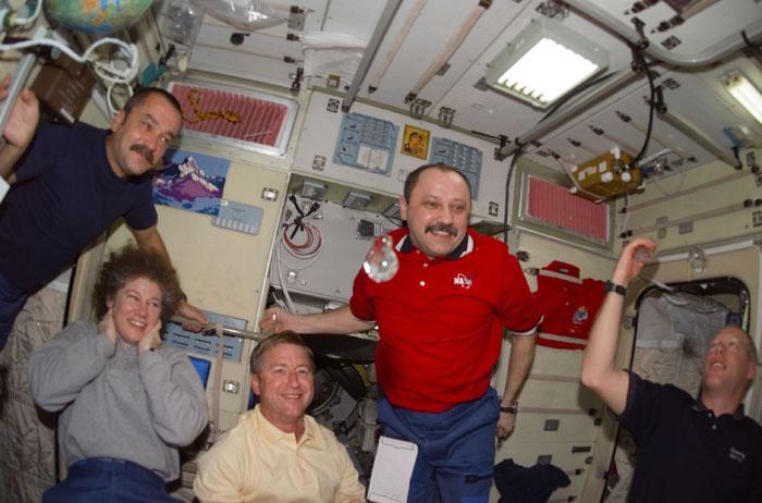 STS105-E-5205 (15 August 2001) --- The astronauts and cosmonauts of STS-105 and Expedition Two and Expedition Three share some time in the Zvezda Service Module aboard the International Space Station. From left to right are cosmonaut Mikhail Tyurin, Expedition Three flight engineer; astronaut Susan J. Helms, Expedition Two flight engineer; astronaut Frank L. Culbertson, Jr., Expedition Three commander; cosmonaut Yury V. Usachev, Expedition Two commander; and Patrick G. Forrester, STS-105 mission specialist. Taking a brief break from busy moving chores, the astronauts and cosmonauts fashioned some liquid bubbles, which always perform interestingly in zero gravity.  The image was recorded with a digital still camera.